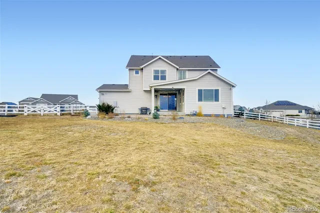 a front view of a house with a yard and a street