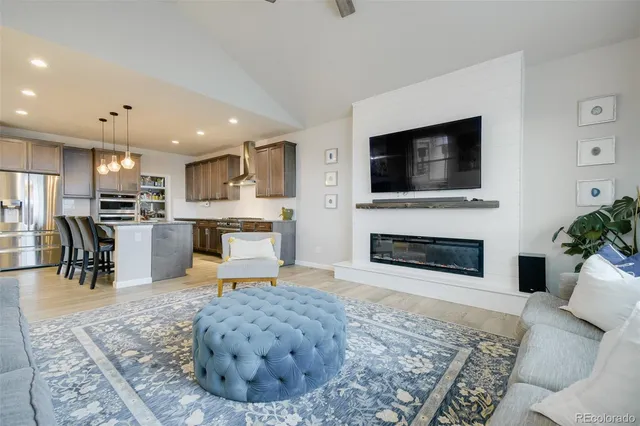 a living room with fireplace furniture and a flat screen tv