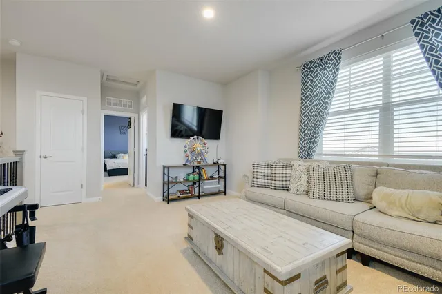 a bedroom with furniture and a flat screen tv