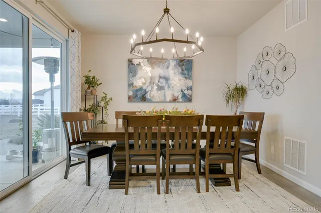 a view of a dining room with furniture wooden floor and a chandelier