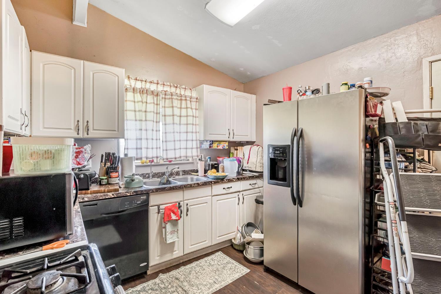 1205 Rogers Street Madera, CA 93638 - Photo 15 of 23 a kitchen with stainless steel appliances granite countertop a refrigerator a stove a sink dishwasher and a stove