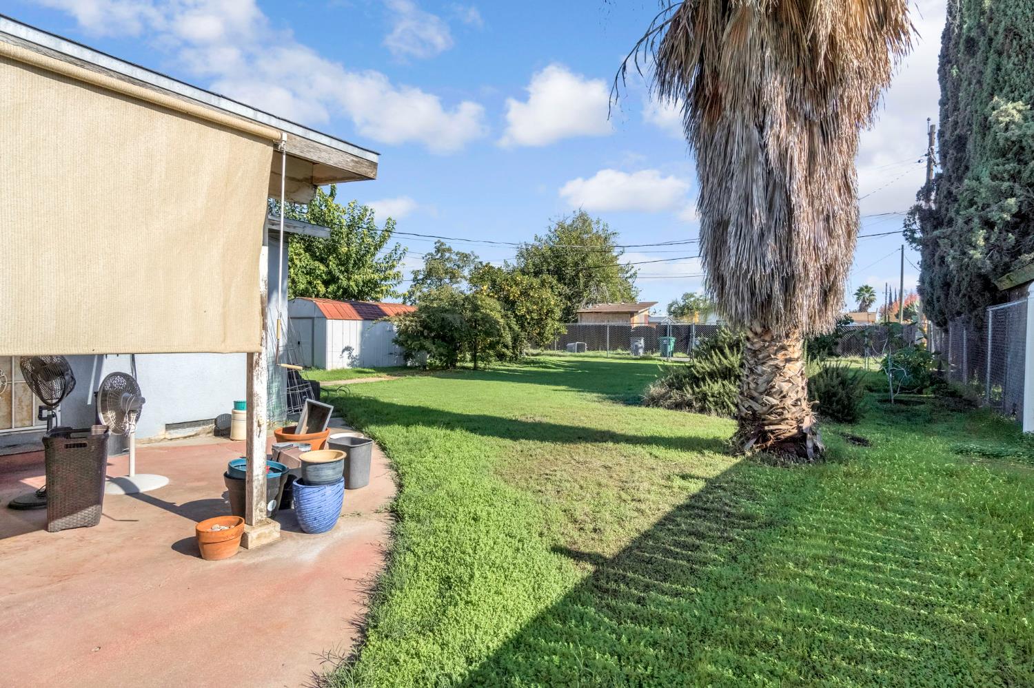 1205 Rogers Street Madera, CA 93638 - Photo 20 of 23 a view of a backyard with couches under an umbrella