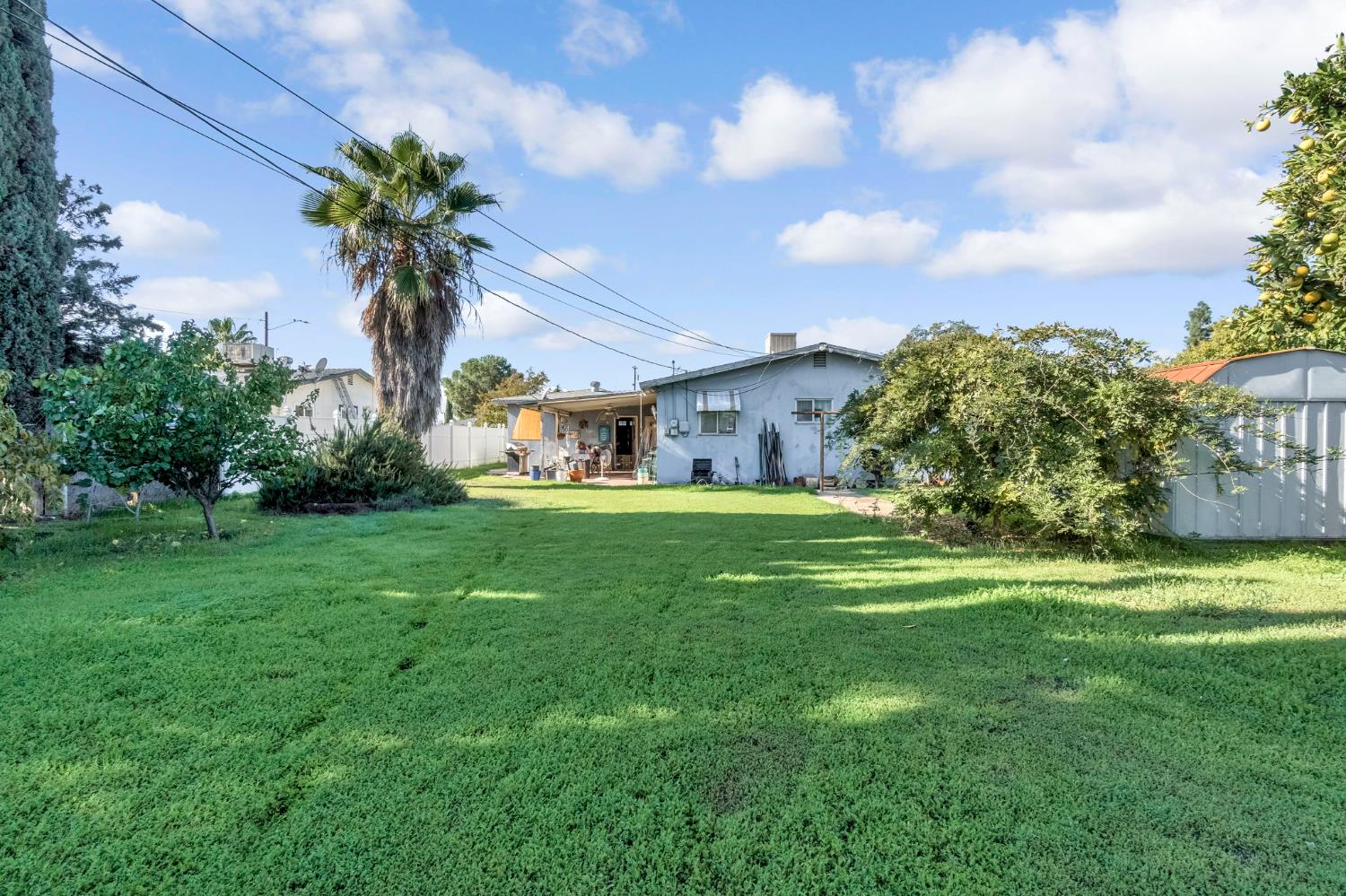 1205 Rogers Street Madera, CA 93638 - Photo 21 of 23 a front view of house with yard and green space