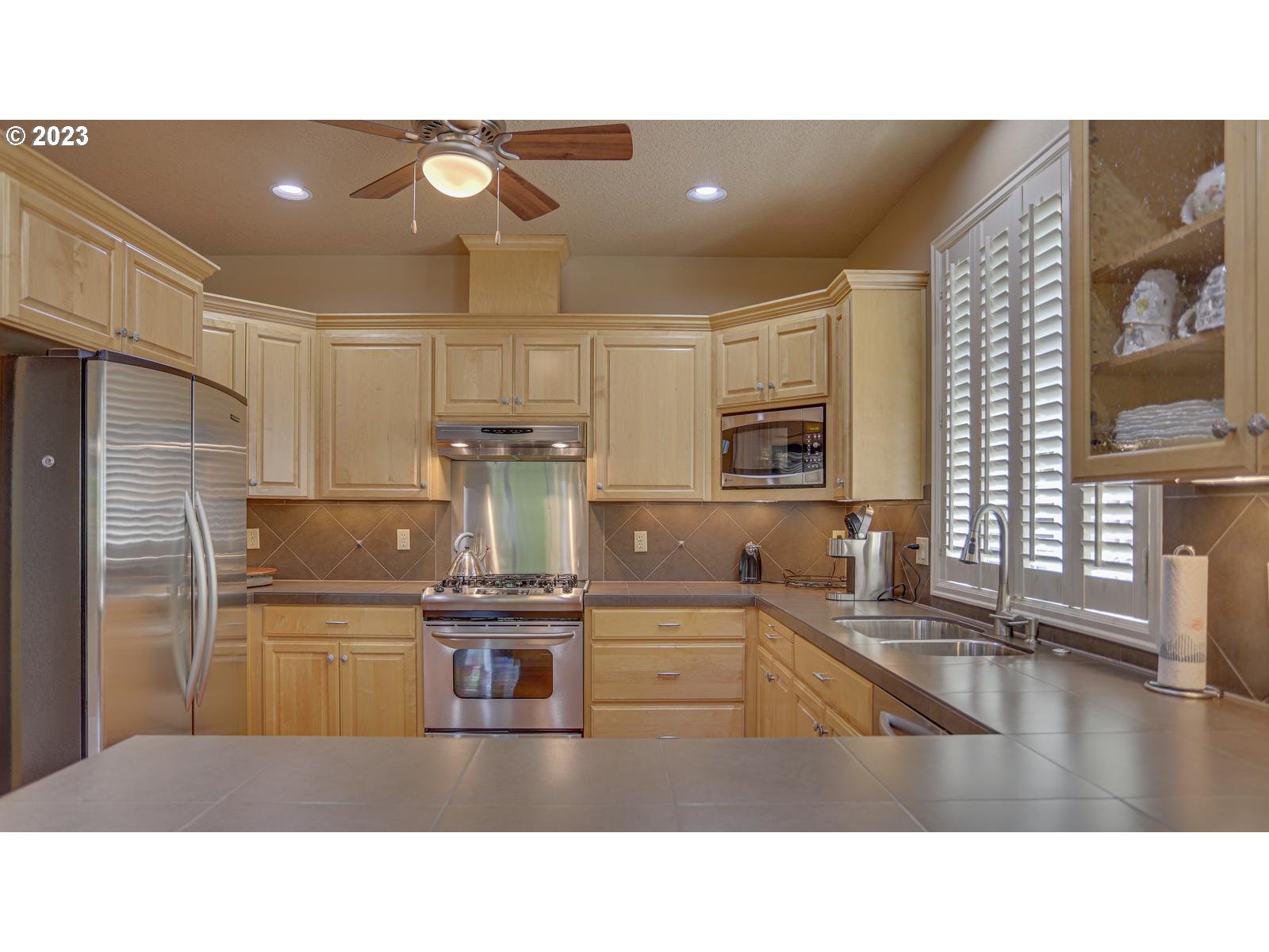 3919 Southeast 31st Street Gresham, OR 97080 - Photo 10 of 26 a kitchen with a sink stainless steel appliances and cabinets