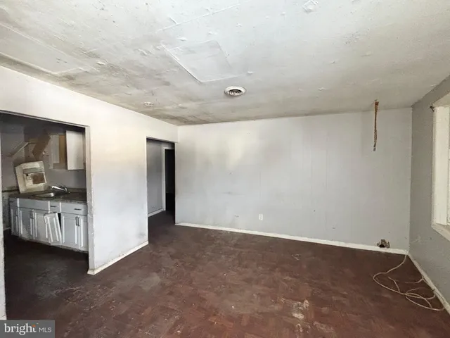 a view of a kitchen with refrigerator and a sink