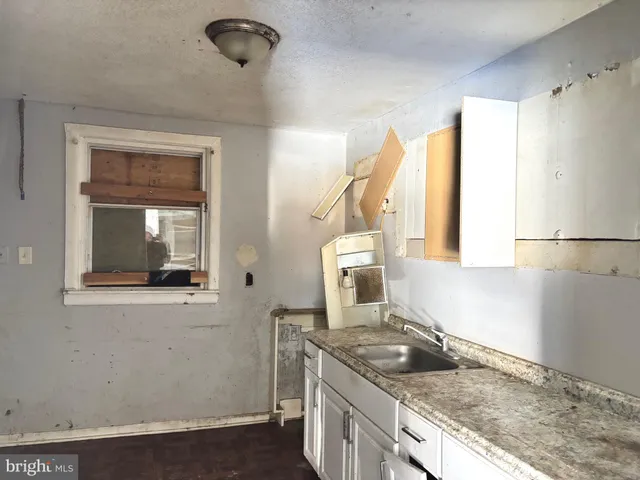 a kitchen with granite countertop a sink and a stove