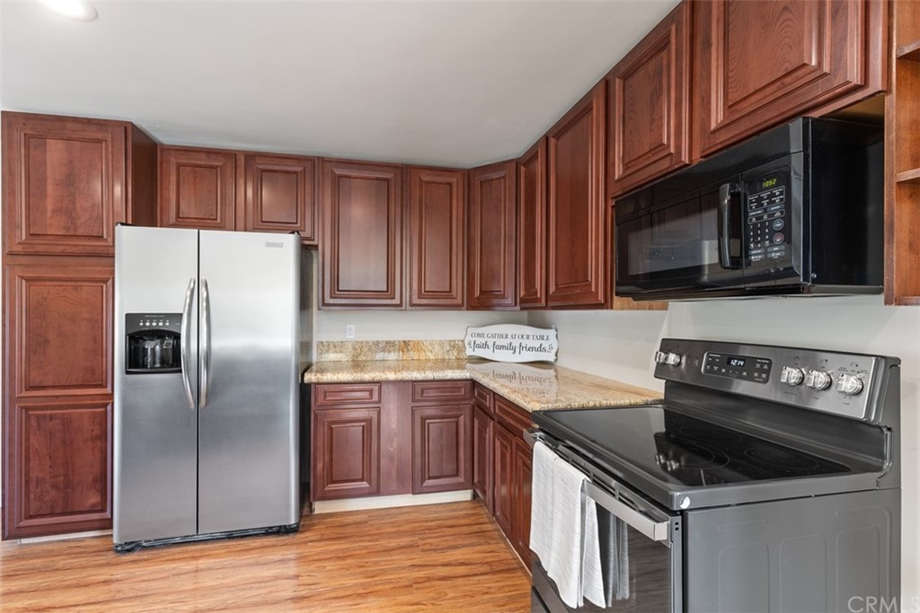 29752 Ivy Glenn Drive Laguna Niguel, CA 92677 - Photo 13 of 36 a kitchen with a sink stove and refrigerator