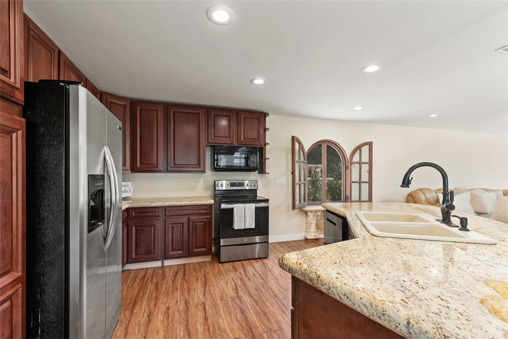 29752 Ivy Glenn Drive Laguna Niguel, CA 92677 - Photo 14 of 36 a kitchen with stainless steel appliances granite countertop a refrigerator a sink a stove and oven
