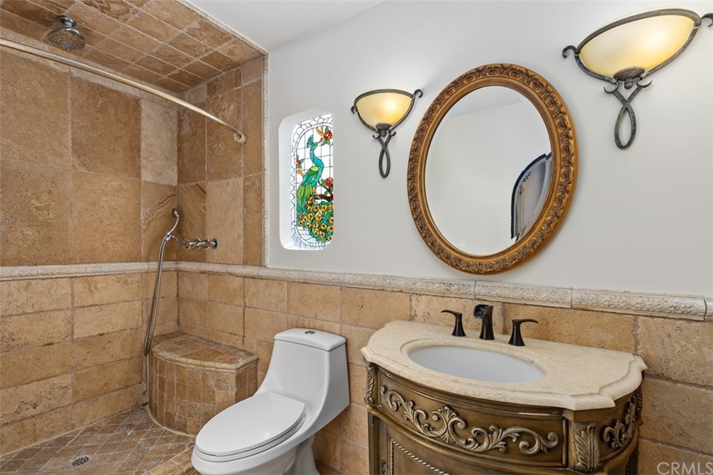 29752 Ivy Glenn Drive Laguna Niguel, CA 92677 - Photo 21 of 36 a bathroom with a toilet a sink and a mirror
