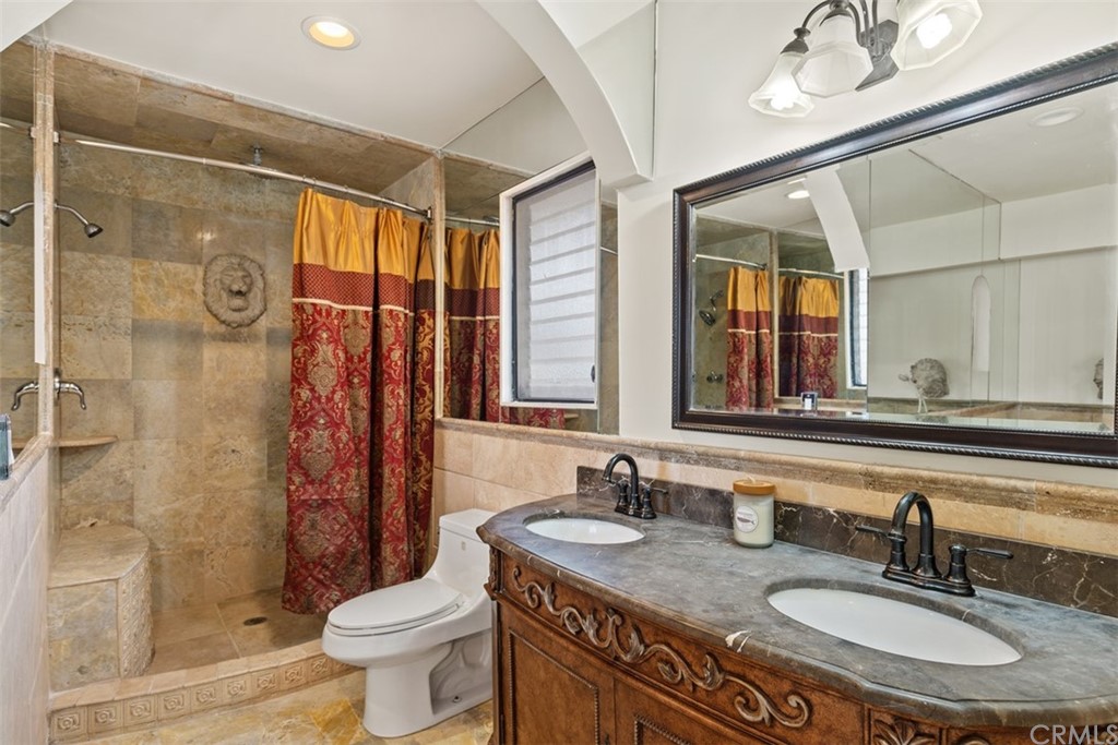 29752 Ivy Glenn Drive Laguna Niguel, CA 92677 - Photo 24 of 36 a bathroom with a granite countertop sink toilet and shower