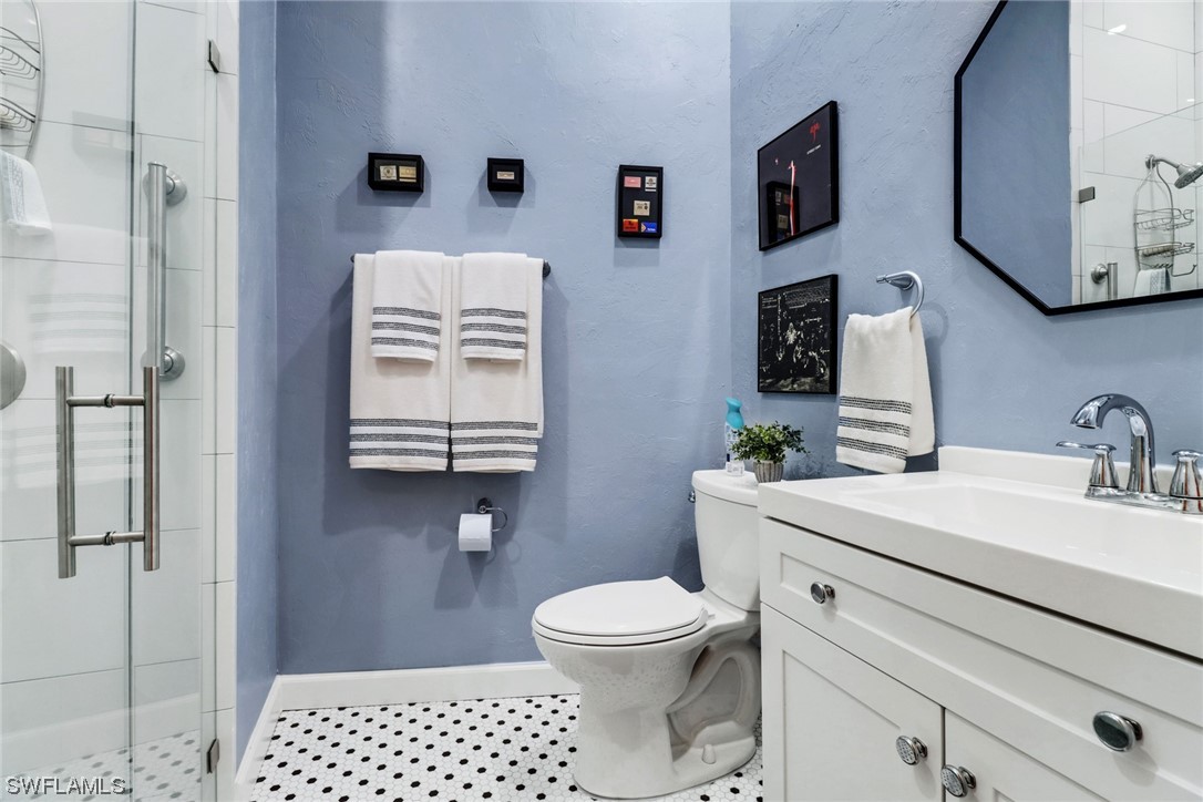 14813 Soaring Eagle Court Fort Myers, FL 33912 - Photo 12 of 19 a bathroom with a sink a toilet and mirror