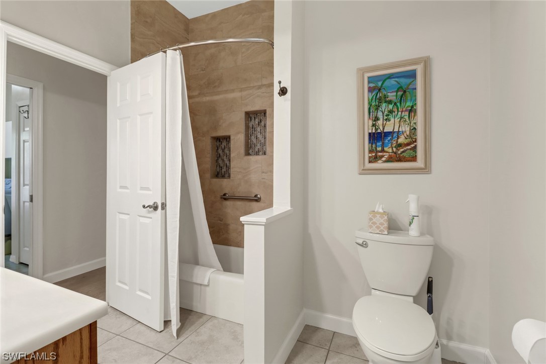 14813 Soaring Eagle Court Fort Myers, FL 33912 - Photo 13 of 19 a white toilet sitting next to a bathroom sink