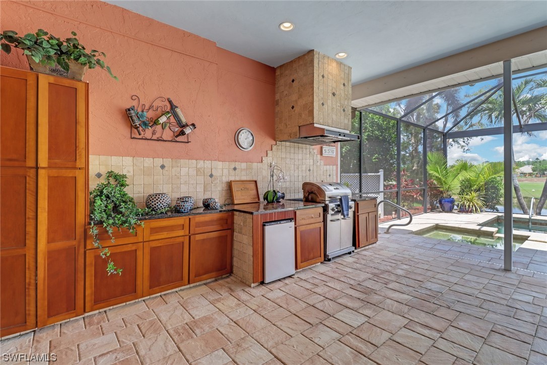 14813 Soaring Eagle Court Fort Myers, FL 33912 - Photo 15 of 19 a kitchen with stainless steel appliances granite countertop a stove a sink and a microwave
