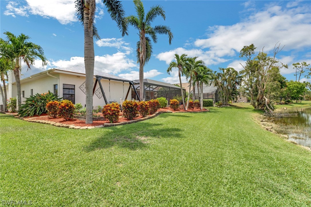 14813 Soaring Eagle Court Fort Myers, FL 33912 - Photo 19 of 19 a view of a backyard with a garden and plants