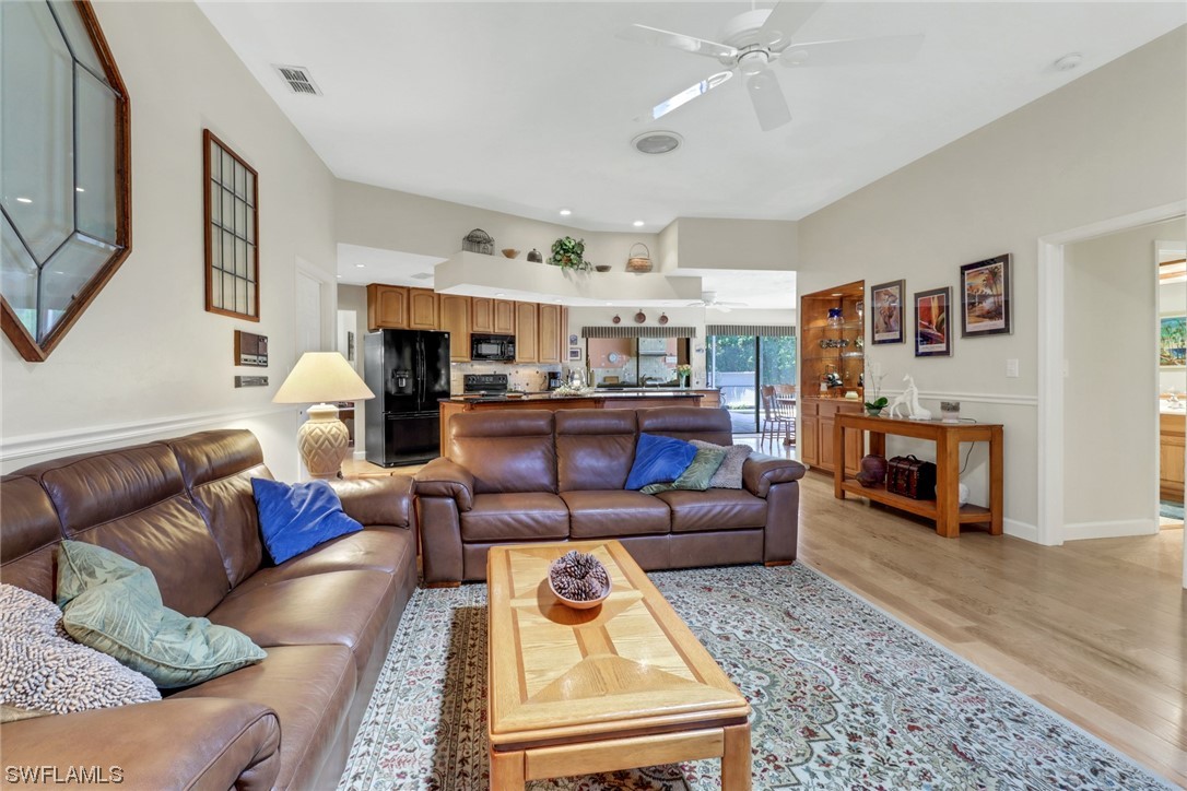 14813 Soaring Eagle Court Fort Myers, FL 33912 - Photo 6 of 19 a living room with furniture and a fireplace