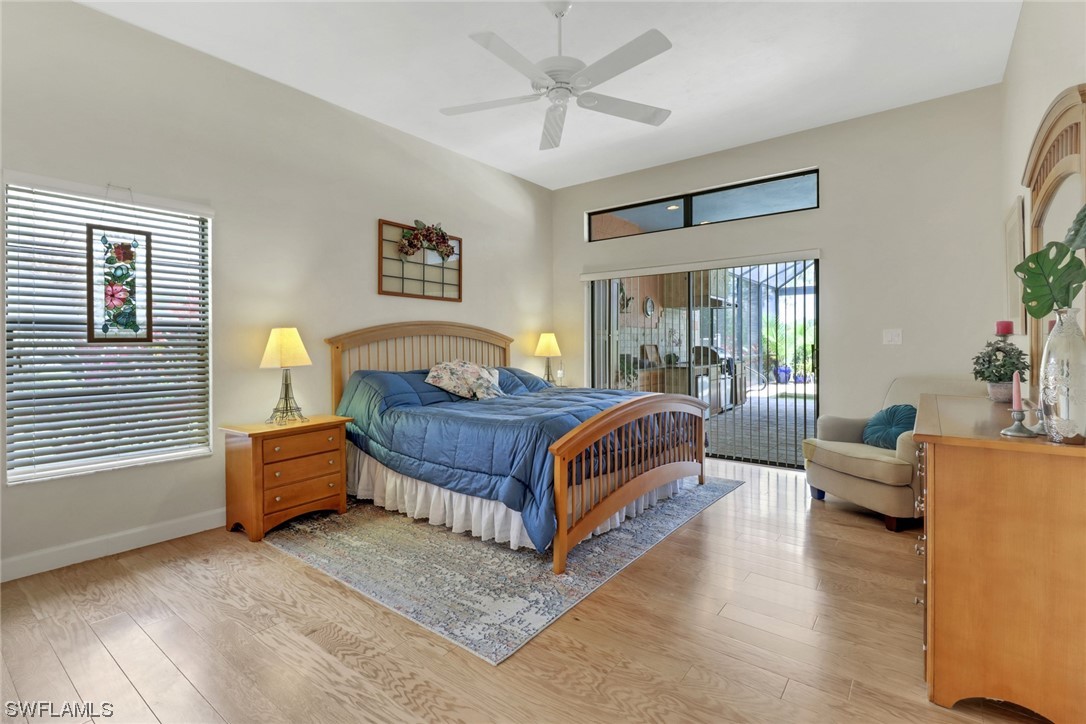 14813 Soaring Eagle Court Fort Myers, FL 33912 - Photo 7 of 19 a bedroom with a bed and wooden floor