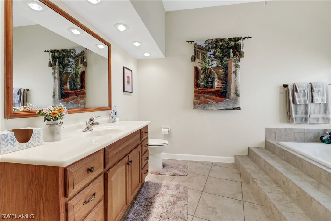 14813 Soaring Eagle Court Fort Myers, FL 33912 - Photo 9 of 19 a bathroom with a double vanity sink mirror and bathtub