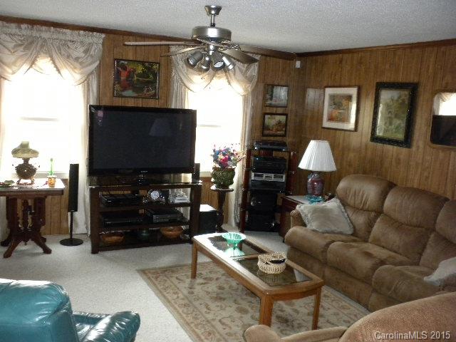 1813 Claude Austin Road Monroe, NC 28112 - Photo 2 of 22 a living room with furniture a window and a flat screen tv