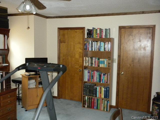 1813 Claude Austin Road Monroe, NC 28112 - Photo 15 of 22 a work room with furniture and a book shelf