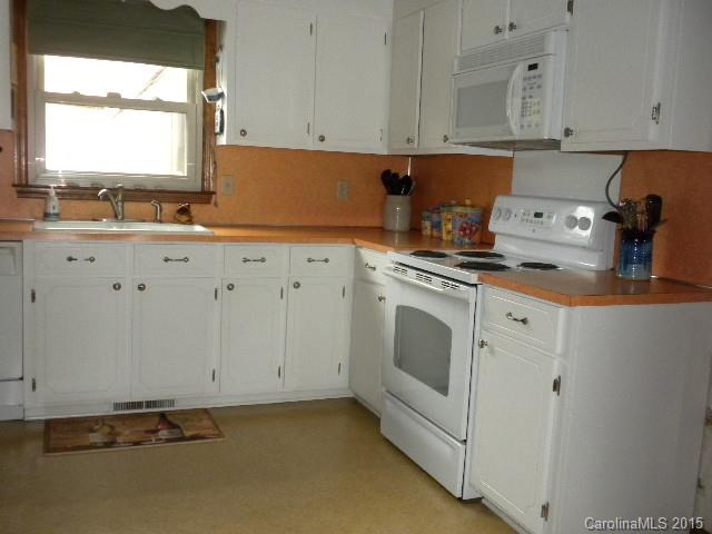 1813 Claude Austin Road Monroe, NC 28112 - Photo 5 of 22 a kitchen with granite countertop white cabinets and white appliances