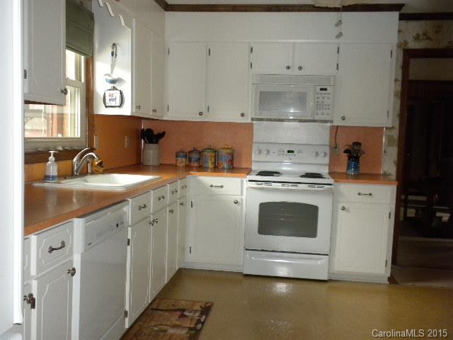 1813 Claude Austin Road Monroe, NC 28112 - Photo 6 of 22 a kitchen with granite countertop white cabinets and white appliances