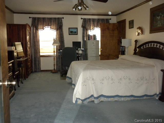 1813 Claude Austin Road Monroe, NC 28112 - Photo 10 of 22 a spacious bedroom with a bed and a walk in closet
