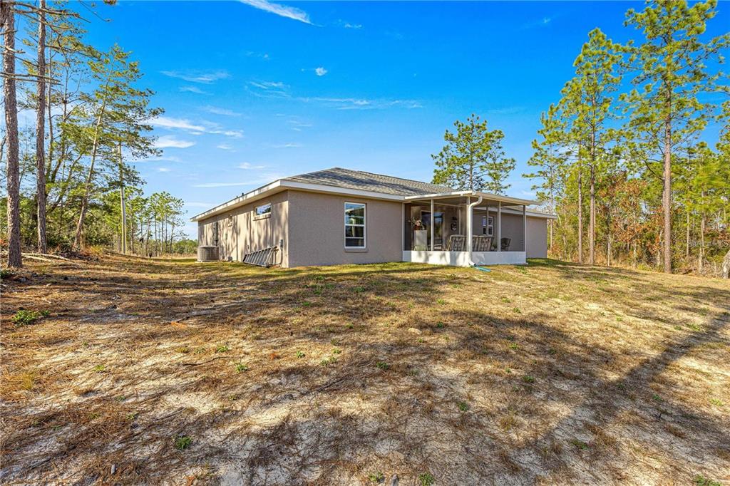 13057 Southwest 85th Circle Ocala, FL 34473 - Photo 5 of 32 a front view of a house with a garden