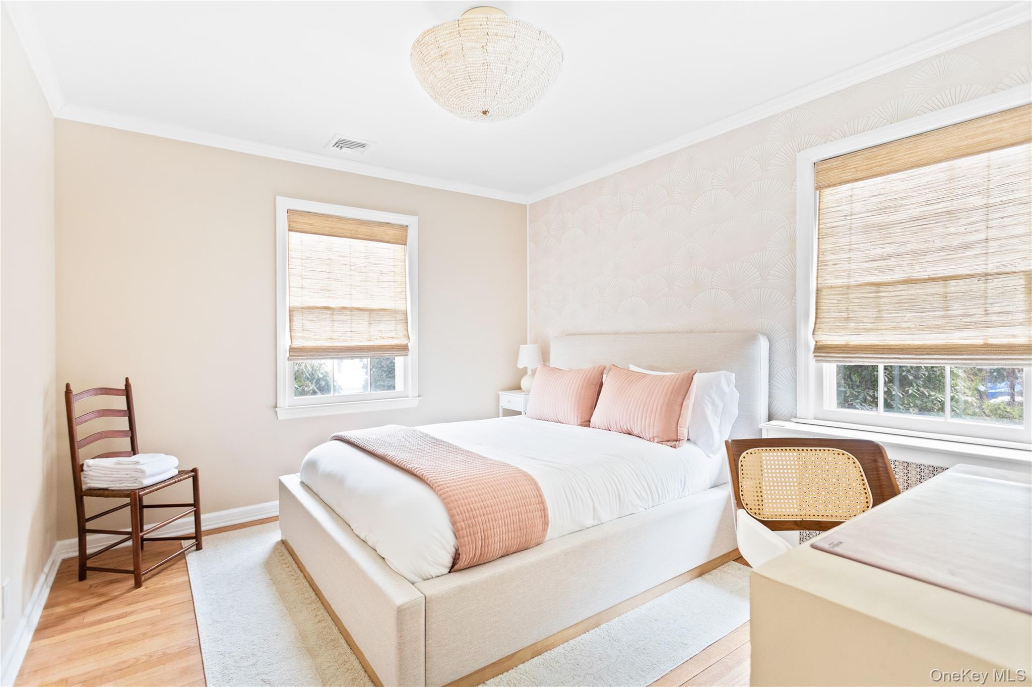 11 Bieselin Road Bellport, NY 11713 - Photo 11 of 17 a bedroom with a bed a table and chair with a large window
