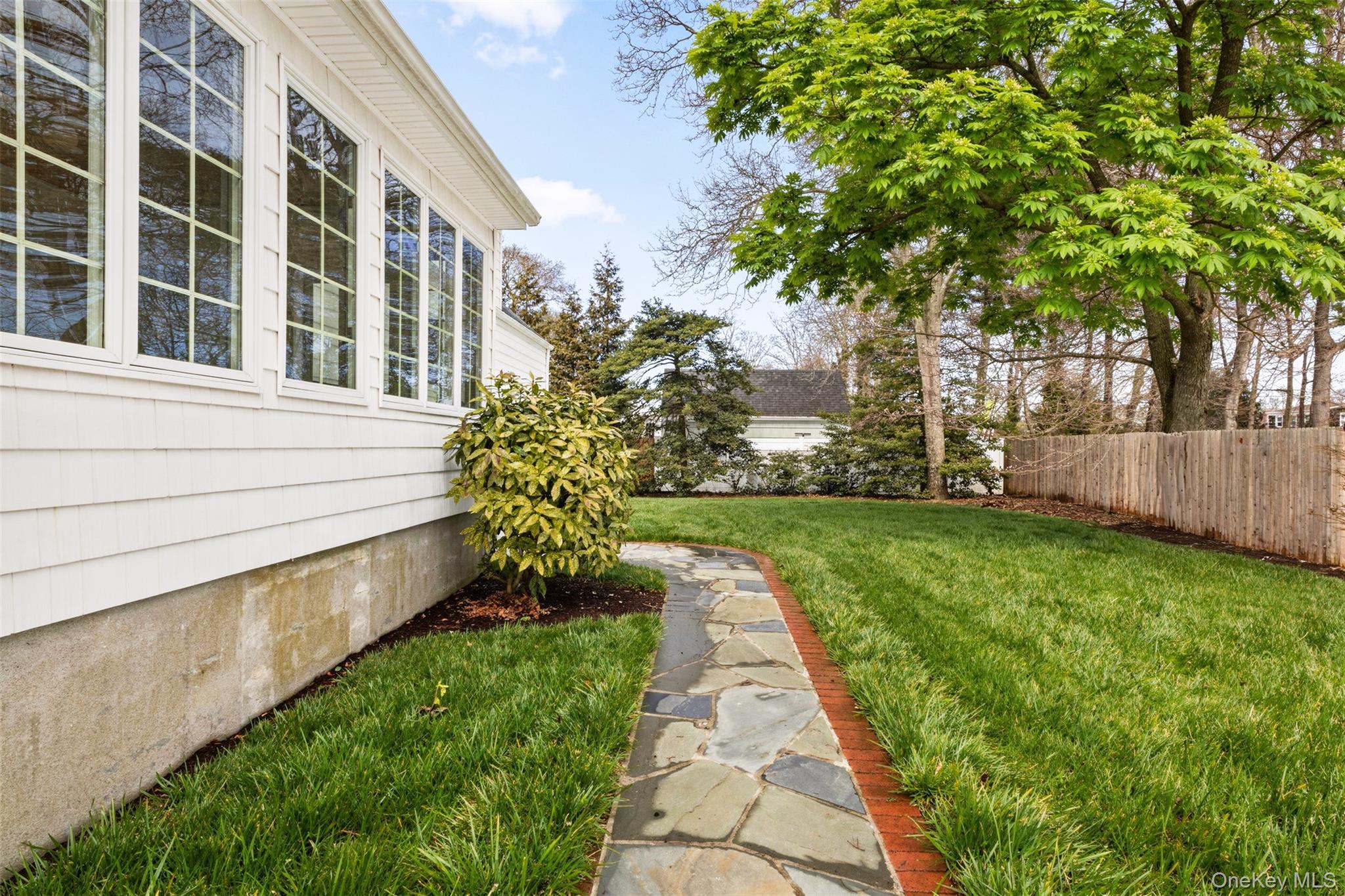 11 Bieselin Road Bellport, NY 11713 - Photo 16 of 17 a view of a pathway with a yard