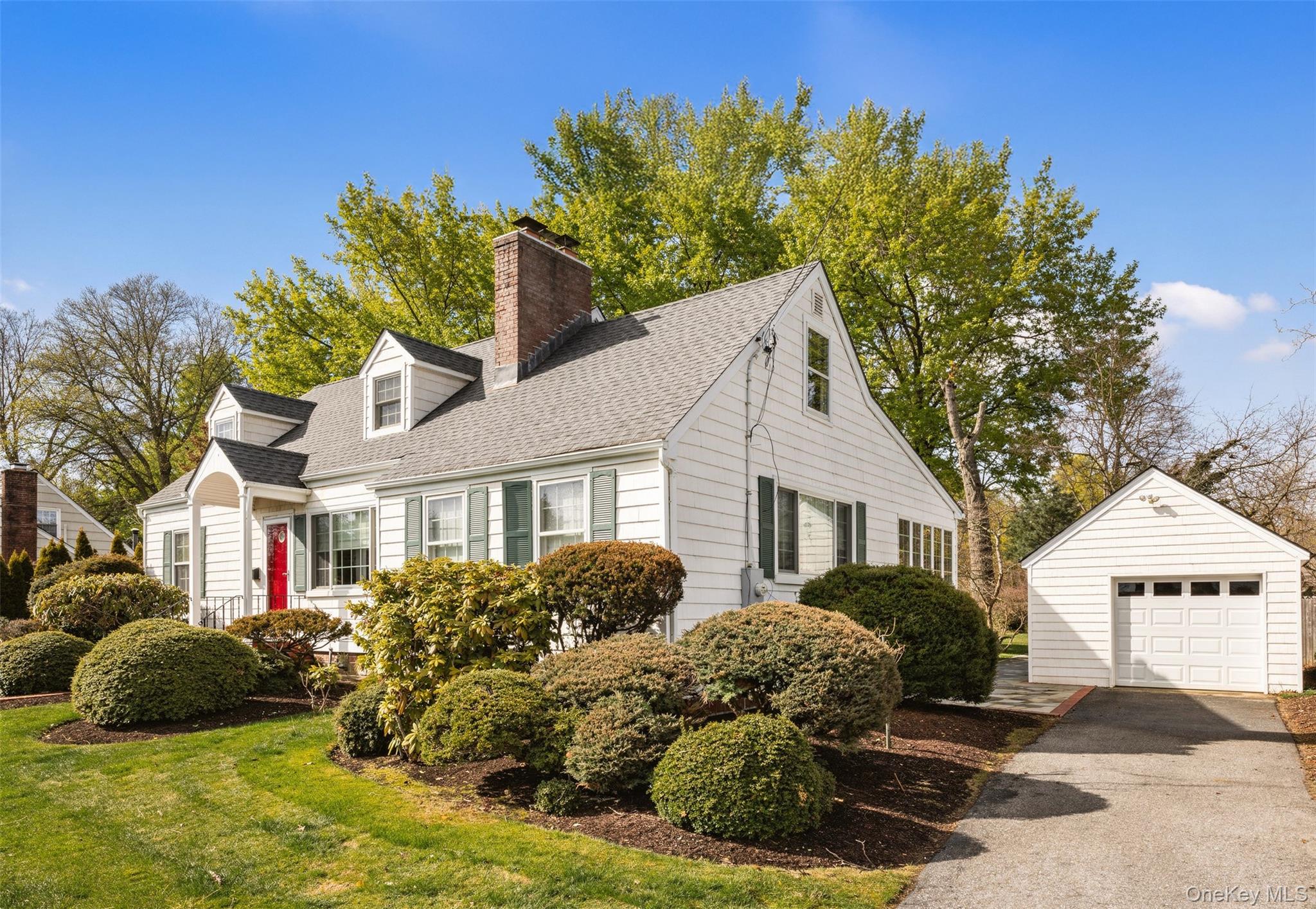 11 Bieselin Road Bellport, NY 11713 - Photo 2 of 17 a front view of a house with a yard