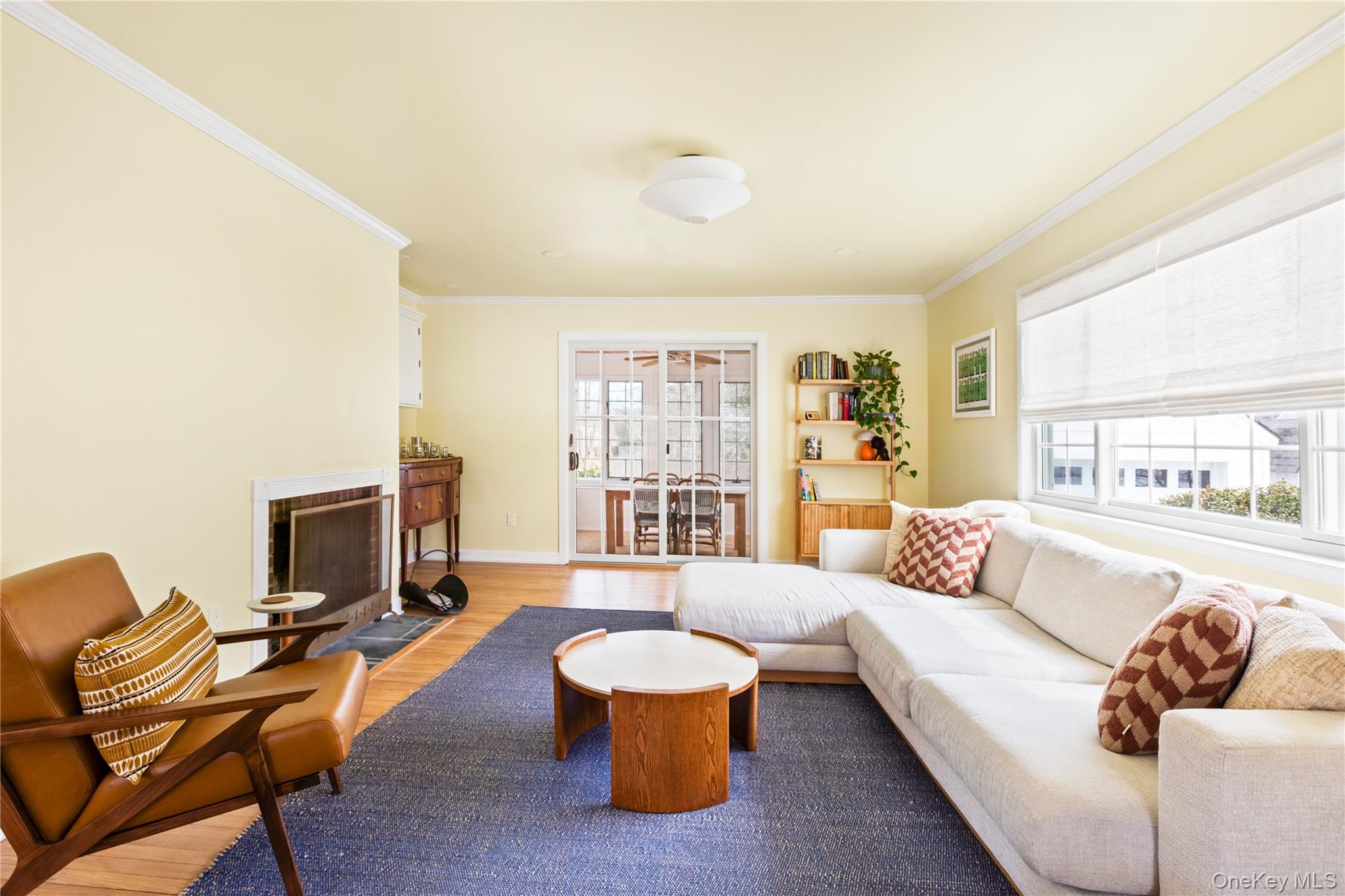 11 Bieselin Road Bellport, NY 11713 - Photo 3 of 17 a living room with furniture and a fireplace