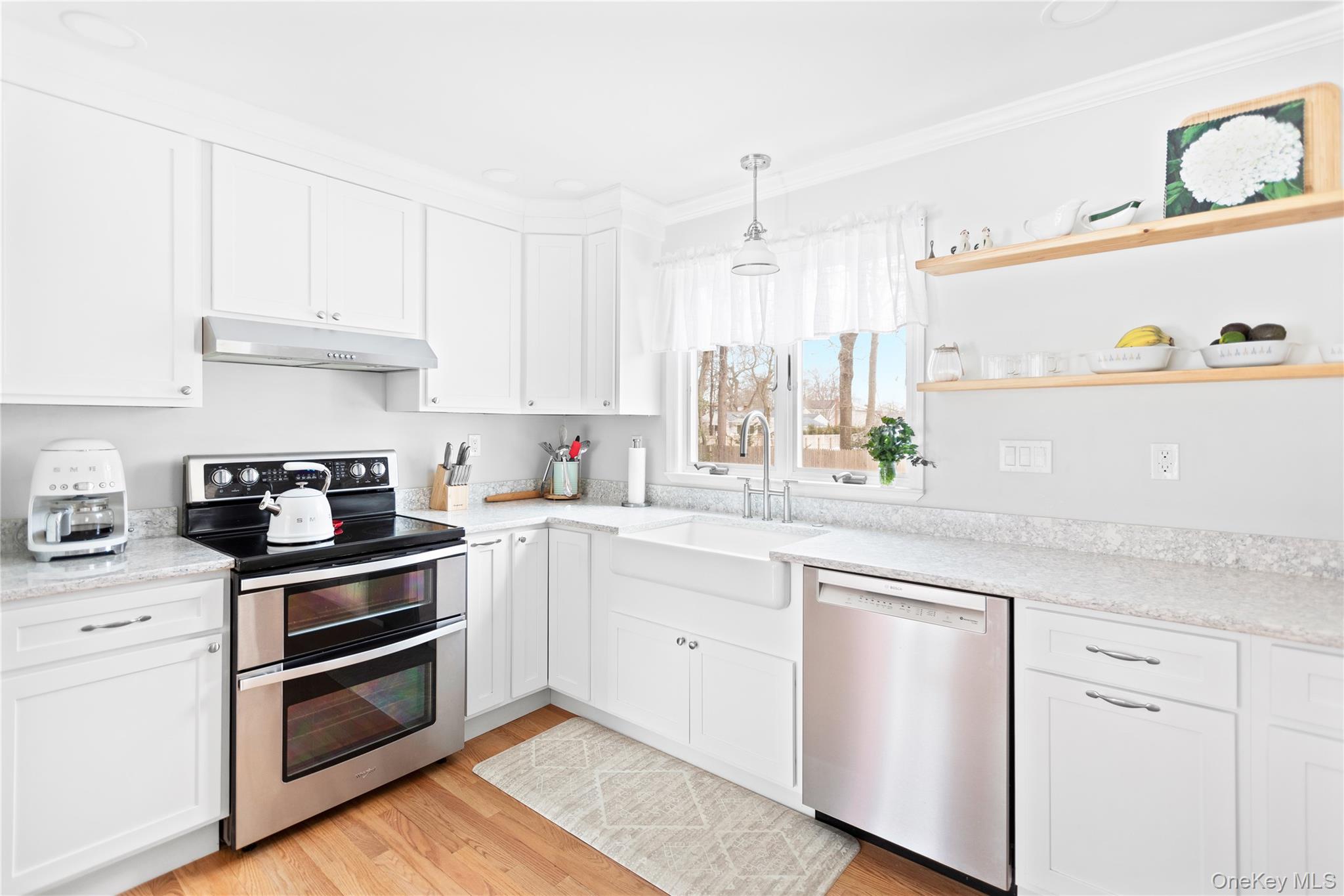 11 Bieselin Road Bellport, NY 11713 - Photo 6 of 17 a kitchen with granite countertop white cabinets and white appliances