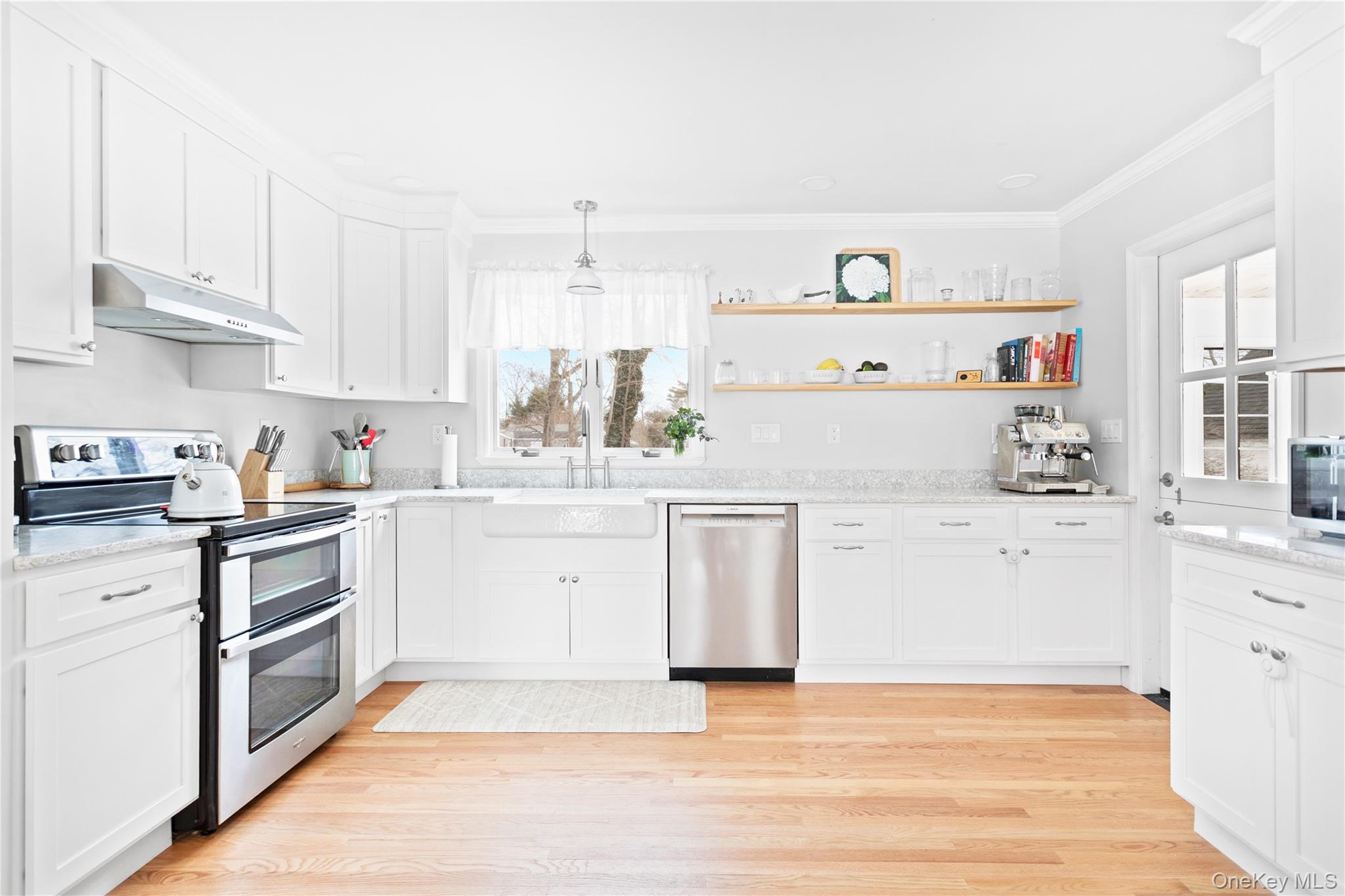 11 Bieselin Road Bellport, NY 11713 - Photo 7 of 17 a kitchen with white cabinets and white appliances
