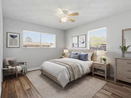 a bedroom with a bed and a table chair
