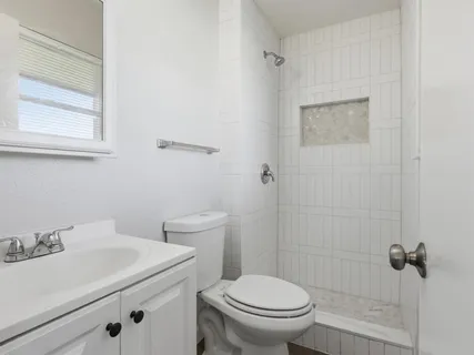 a bathroom with a sink toilet and a mirror