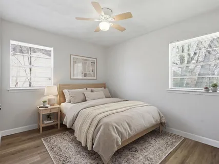 a bedroom with a large bed and a window