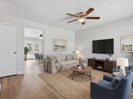 a living room with furniture and a flat screen tv