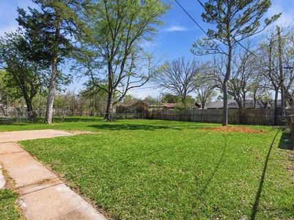a view of a park with large trees