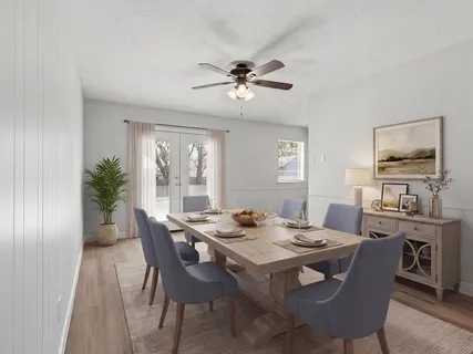 a view of a dining room with furniture window and wooden floor