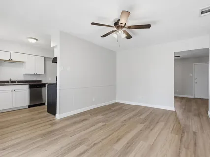 a view of a kitchen with a sink and wooden floor