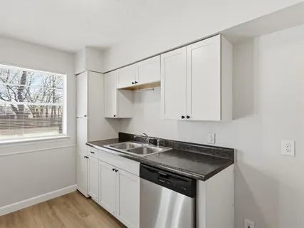 a kitchen with stainless steel appliances granite countertop a sink stove and cabinets