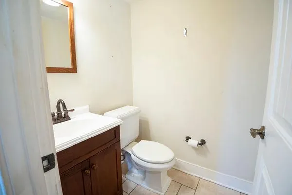 a bathroom with a sink a toilet and mirror