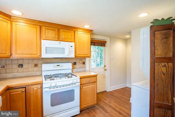 a kitchen with a stove a sink and a refrigerator