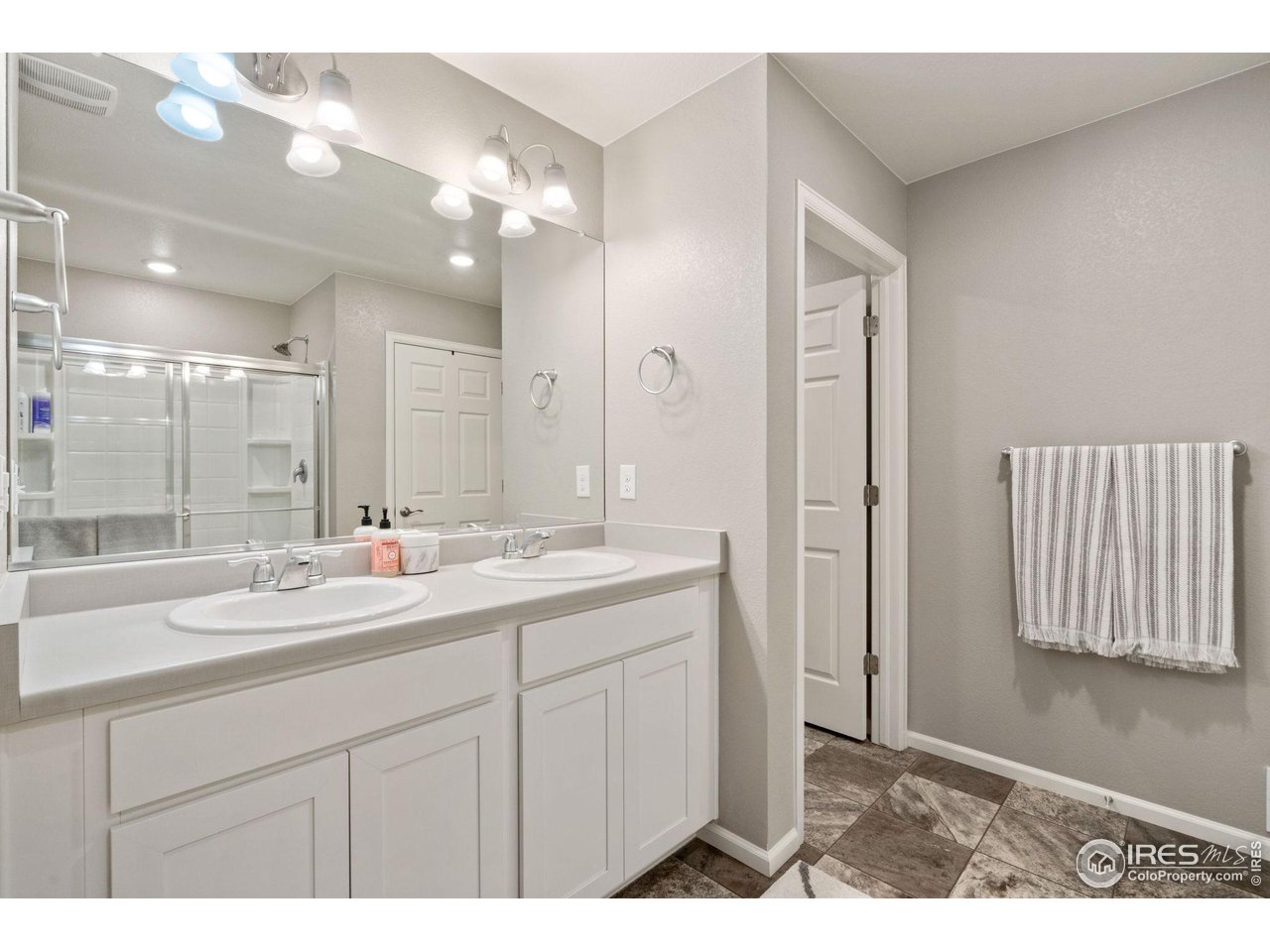 176 Haymaker Lane Severance, CO 80550 - Photo 18 of 25 a bathroom with a sink double vanity and a mirror
