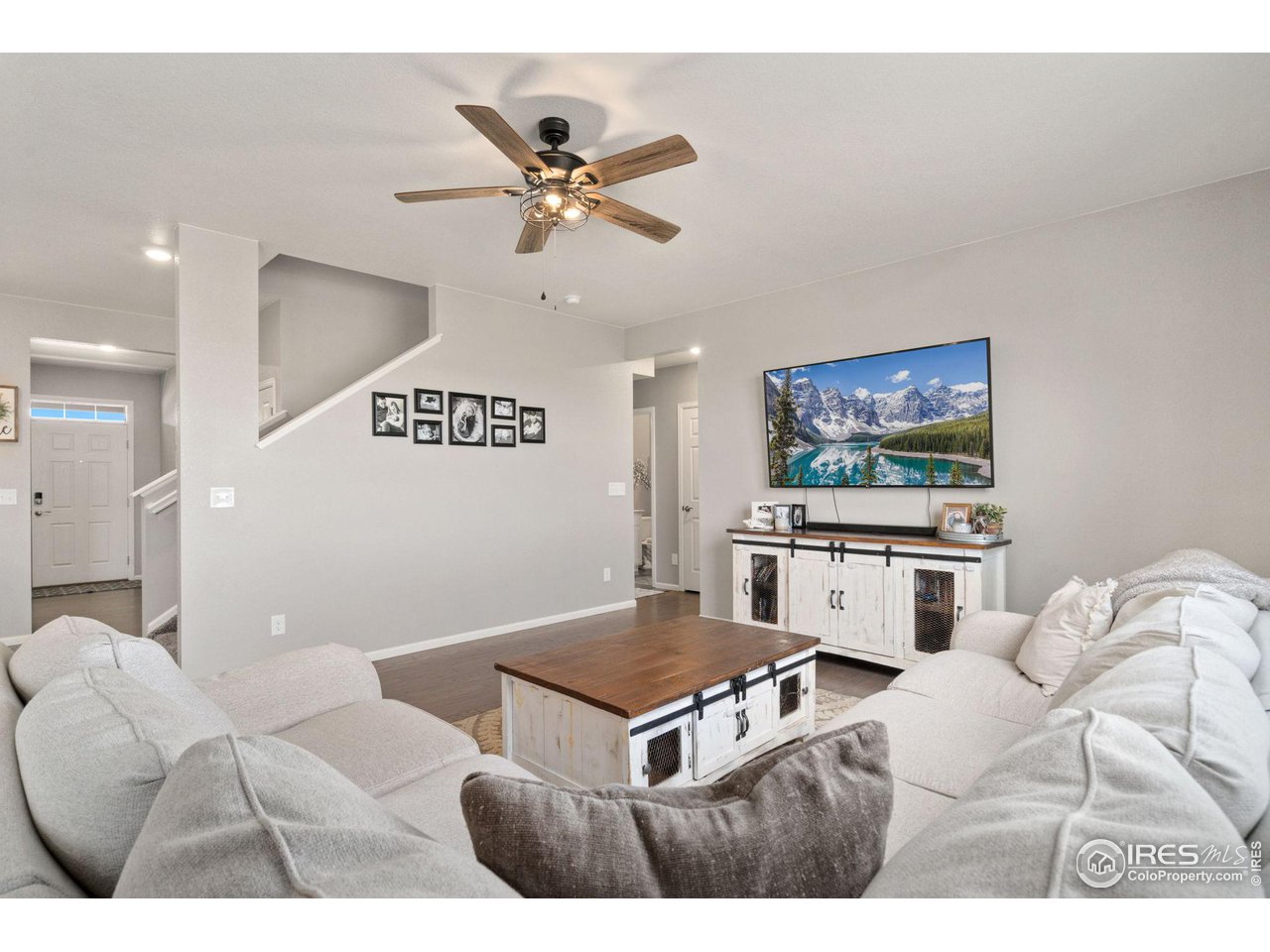 176 Haymaker Lane Severance, CO 80550 - Photo 7 of 25 a living room with furniture a flat screen tv and kitchen view