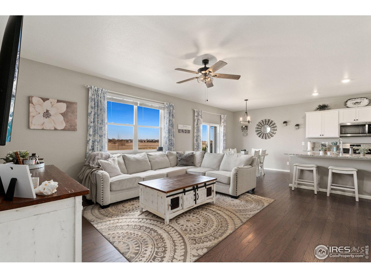 176 Haymaker Lane Severance, CO 80550 - Photo 8 of 25 a living room with furniture or chandelier and a wooden floor