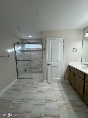 a bathroom with a shower and a sink