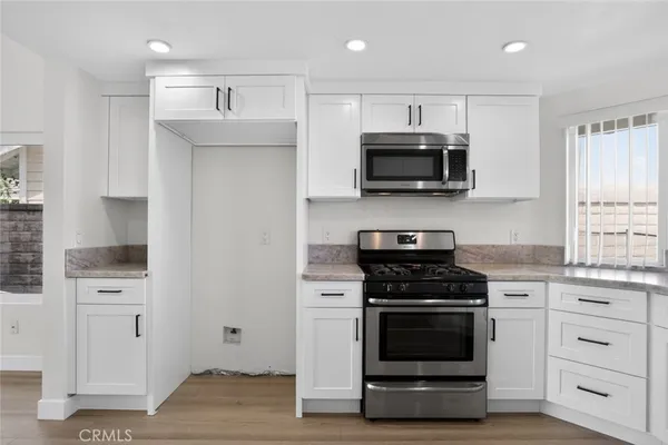 a kitchen with a stove and a microwave