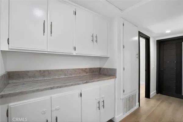 a view of cabinets and wooden floor