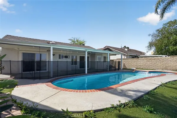 a view of a house with swimming pool and yard